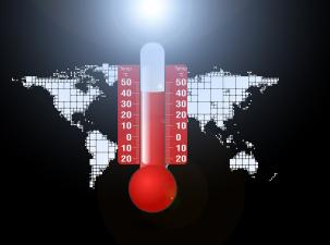 Weltkarte mit einem Thermometer im Vordergrund