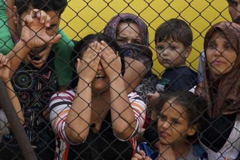 Mehrere Gefl&uuml;chtete, darunter viele Kinder, an einem Zaun